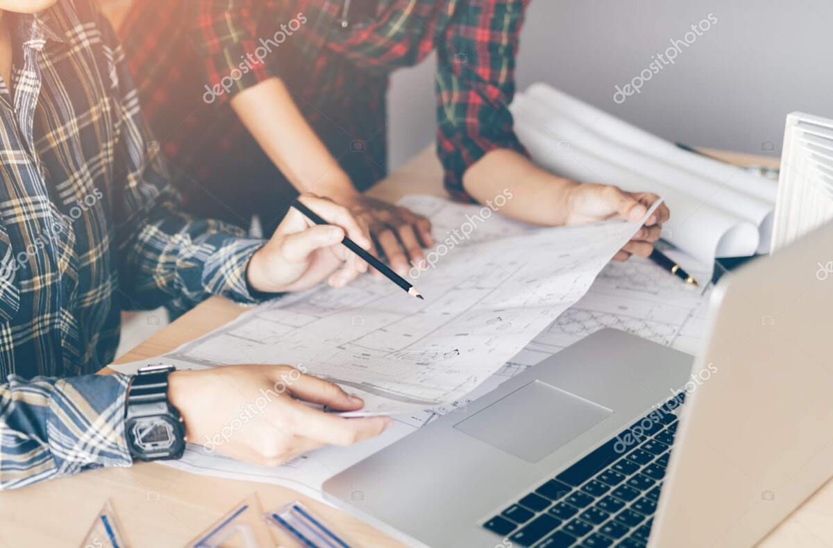 two engineering man or co workers working on a project and discu