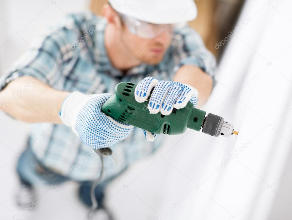 depositphotos 30211323 stock photo man drilling the wall